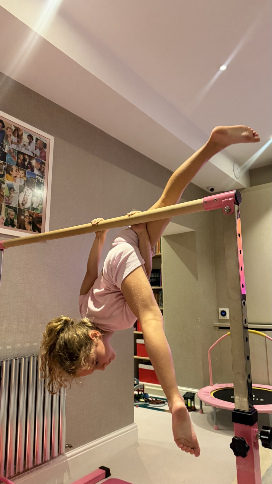A young gymnast training on the bars in the Rosae studio